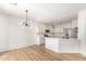 Open-concept kitchen boasts white cabinets, stainless steel appliances, and a stylish, modern pendant light at 1265 S Aaron -- # 271, Mesa, AZ 85209