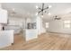 Open-concept kitchen and living space boasts white cabinets, stainless steel appliances, and modern lighting at 1265 S Aaron -- # 271, Mesa, AZ 85209
