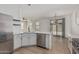 Stylish kitchen features white cabinets, quartz countertops, stainless steel appliances, and wood flooring at 1265 S Aaron -- # 271, Mesa, AZ 85209