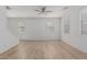 Bright living room with neutral paint, wood floors, a ceiling fan, and sun-filled windows at 1265 S Aaron -- # 271, Mesa, AZ 85209
