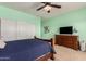 Bedroom with green walls, ceiling fan, closet, dresser and a view of the carpeted floor at 1453 E Elgin Pl, Chandler, AZ 85225