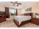 Cozy bedroom with ceiling fan, neutral walls, and large window that provides natural light at 1453 E Elgin Pl, Chandler, AZ 85225