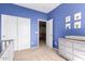 Bedroom room with blue walls, gray dresser and closet with sliding doors at 1453 E Elgin Pl, Chandler, AZ 85225