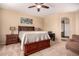 Comfortable bedroom with ceiling fan, neutral walls, artwork, and a view to the ensuite bathroom at 1453 E Elgin Pl, Chandler, AZ 85225