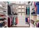 Well-organized walk-in closet with shelving, hanging rods, drawers, and storage boxes at 1453 E Elgin Pl, Chandler, AZ 85225