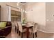 Cozy dining area with a modern chandelier, seating for six, and bright window light at 1453 E Elgin Pl, Chandler, AZ 85225