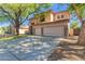 Attractive two-story home featuring a spacious driveway, mature trees, and a three-car garage at 1453 E Elgin Pl, Chandler, AZ 85225