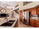 Modern kitchen with stainless steel appliances, granite countertops, and breakfast bar seating at 1453 E Elgin Pl, Chandler, AZ 85225