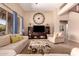Inviting living room with a large wall clock, stylish furniture, and natural light at 1453 E Elgin Pl, Chandler, AZ 85225