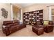 Cozy living room with plush seating, a built-in bookcase, and warm, neutral tones at 1453 E Elgin Pl, Chandler, AZ 85225