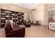 Spacious living room with a large bookcase, comfortable seating, and an adjacent dining area at 1453 E Elgin Pl, Chandler, AZ 85225