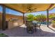 Outdoor kitchen with stainless steel grill, sink and refrigerator, ceiling fan and paver patio by the pool at 1453 E Elgin Pl, Chandler, AZ 85225