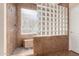 Tiled shower with glass block divider, built-in bench, and a handheld shower head at 1453 E Elgin Pl, Chandler, AZ 85225