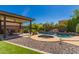 Backyard oasis with a private pool, spa, rock waterfall feature, covered patio with an outdoor kitchen at 1453 E Elgin Pl, Chandler, AZ 85225