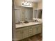 A spacious bathroom includes double sinks, generous storage, and a large vanity mirror at 14575 W Mountain View Blvd # 711, Surprise, AZ 85374