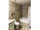 Bathroom features include a shower over tub, framed beach decor, and a neutral color scheme at 14575 W Mountain View Blvd # 711, Surprise, AZ 85374
