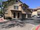Charming two-story townhome featuring arched doorways and private garages, with desert landscaping at 14575 W Mountain View Blvd # 711, Surprise, AZ 85374