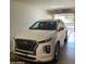 View of a clean, well-lit garage featuring a white SUV parked inside at 14575 W Mountain View Blvd # 711, Surprise, AZ 85374