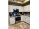 Updated kitchen showcasing stainless steel appliances, granite countertops, and neutral backsplash at 14575 W Mountain View Blvd # 711, Surprise, AZ 85374