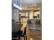 Open-concept kitchen and dining area with granite countertop bar and pendant lighting at 14575 W Mountain View Blvd # 711, Surprise, AZ 85374