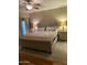 Comfortable main bedroom features a ceiling fan, neutral colors, and an upholstered headboard at 14575 W Mountain View Blvd # 711, Surprise, AZ 85374
