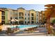Relaxing community pool features many chairs, tables with umbrellas, and an outdoor eating area at 14575 W Mountain View Blvd # 711, Surprise, AZ 85374