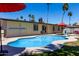 Lovely backyard featuring a pool, manicured lawn, and patio area for outdoor relaxation and recreation at 1535 E Kenwood St, Mesa, AZ 85203