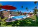 Expansive backyard showcasing a pool, lush lawn, and ample space for outdoor activities and entertaining at 1535 E Kenwood St, Mesa, AZ 85203