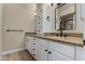 Well-lit bathroom featuring double sinks, granite countertop, modern fixtures, and decorative mirror at 1535 E Kenwood St, Mesa, AZ 85203