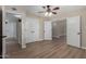 Spacious bedroom with wood-look floors, featuring a ceiling fan and a doorway to another room at 1535 E Kenwood St, Mesa, AZ 85203