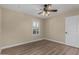 Bedroom with a ceiling fan, shuttered window, and light-toned laminate flooring at 1535 E Kenwood St, Mesa, AZ 85203