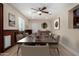 A formal dining room is furnished with a long wooden table, seating for ten, and recessed lighting at 1535 E Kenwood St, Mesa, AZ 85203