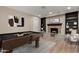 A recreational room features a pool table, a fireplace, custom shelving, and neutral walls at 1535 E Kenwood St, Mesa, AZ 85203