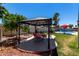 Charming gazebo and dining set in backyard with view of pool and mature landscaping at 1535 E Kenwood St, Mesa, AZ 85203