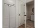 Hallway with storage closet leads to a modern bathroom with bright lighting at 1535 E Kenwood St, Mesa, AZ 85203