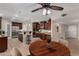 An open kitchen features wood cabinets, granite counters, a stainless fridge, and a center island with bar seating at 1535 E Kenwood St, Mesa, AZ 85203