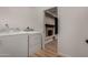 Convenient laundry area with washer and dryer, leading into a finished basement at 1535 E Kenwood St, Mesa, AZ 85203