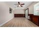 Open room features wood paneling, a ceiling fan, and doors leading to an outdoor area at 1535 E Kenwood St, Mesa, AZ 85203