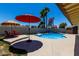 Relaxing backyard featuring a private pool, patio area with seating, and lush landscaping for outdoor enjoyment at 1535 E Kenwood St, Mesa, AZ 85203