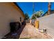 Side yard with brick pathway and access to the backyard with utility access at 1535 E Kenwood St, Mesa, AZ 85203