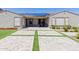 A well-maintained backyard with artificial grass, solar panels, covered patio and sitting area with paver design at 15753 W Christy Dr, Surprise, AZ 85379