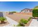 Spacious backyard with gravel and lush landscaping, perfect for outdoor enjoyment at 15753 W Christy Dr, Surprise, AZ 85379