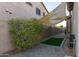 Backyard featuring gravel, synthetic grass rectangle, and an overhead sunshade at 15753 W Christy Dr, Surprise, AZ 85379