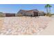 The exterior features a spacious, multicolor brick driveway leading to the home and two-car garage at 15753 W Christy Dr, Surprise, AZ 85379