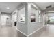 Hallway showcasing open concept with gray walls and neutral tile flooring, leading to other rooms at 15753 W Christy Dr, Surprise, AZ 85379