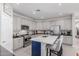 Well-appointed kitchen features white cabinets, stainless appliances, a center island with bar seating and stylish backsplash at 15753 W Christy Dr, Surprise, AZ 85379