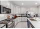 Modern kitchen with stainless appliances, center island with sink, stone countertops, and ample cabinet space at 15753 W Christy Dr, Surprise, AZ 85379