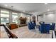 A shot of the living area, complete with a fireplace, windows for natural light, seating, and a pool table at 15753 W Christy Dr, Surprise, AZ 85379