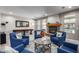 Bright living area with a fireplace, large windows, seating, and a pool table for entertainment at 15753 W Christy Dr, Surprise, AZ 85379