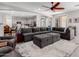 Open concept living room with kitchen view, large sectional sofa and modern decor creates a cozy atmosphere at 15753 W Christy Dr, Surprise, AZ 85379